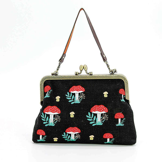 a black purse with mushrooms on it