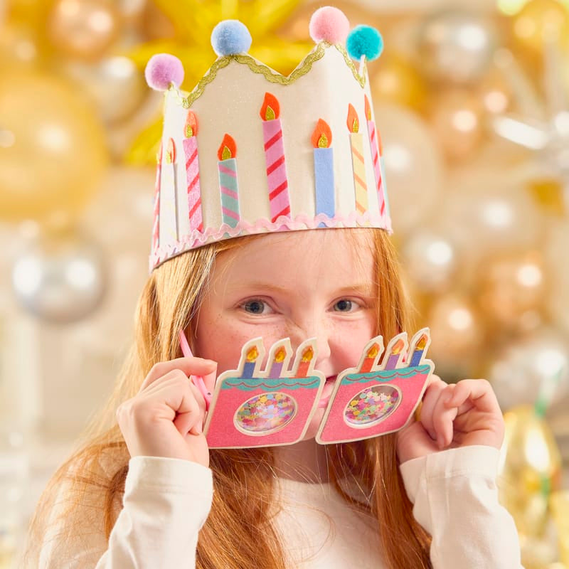 a girl holding a paper crown