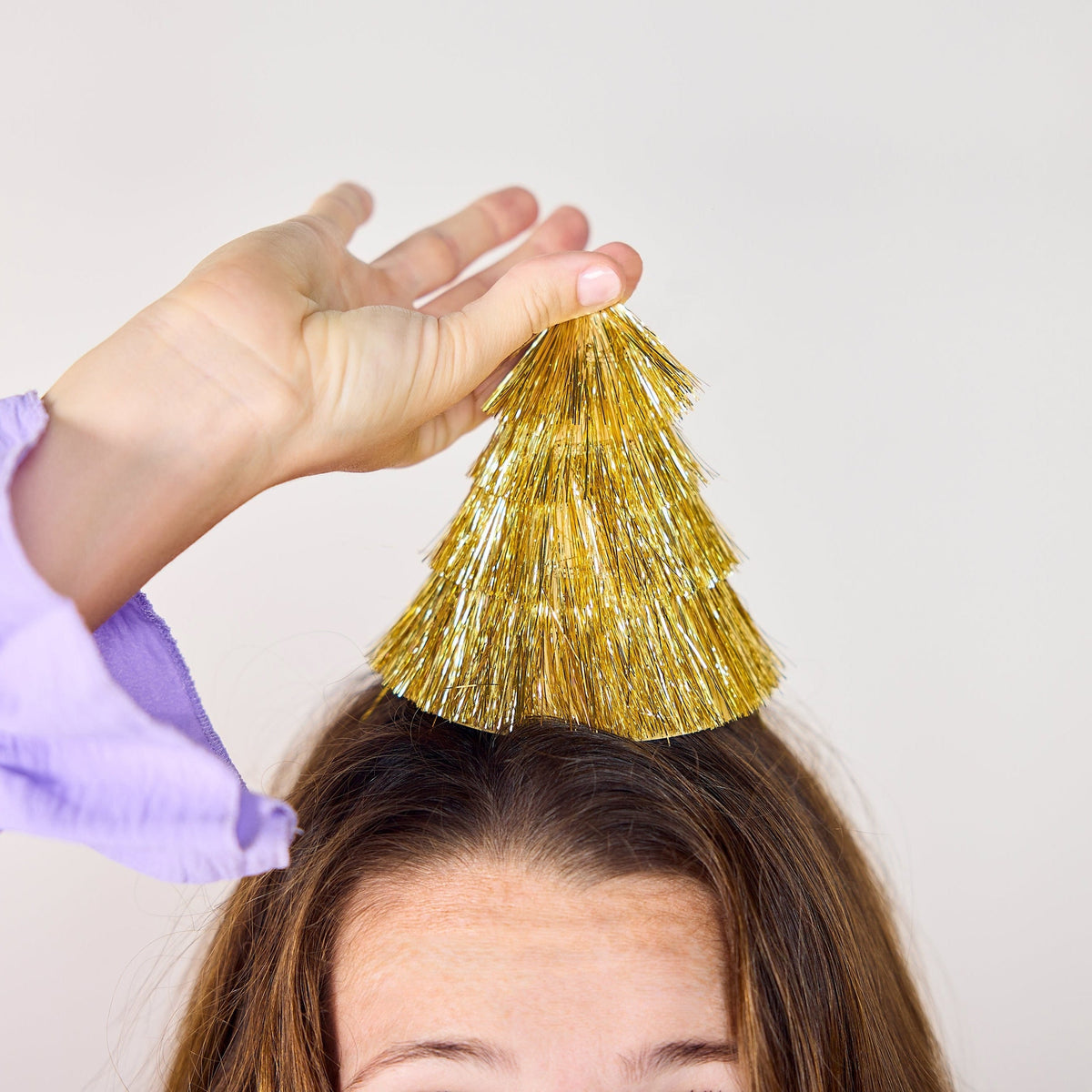 a woman with a gold tassel on her head