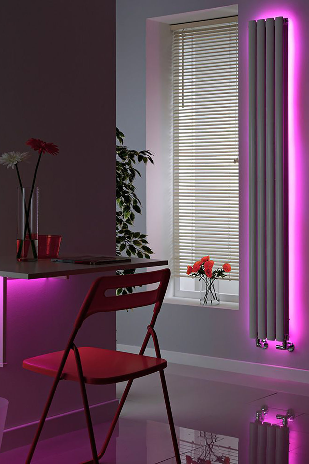 a pink and purple room with a desk and a chair