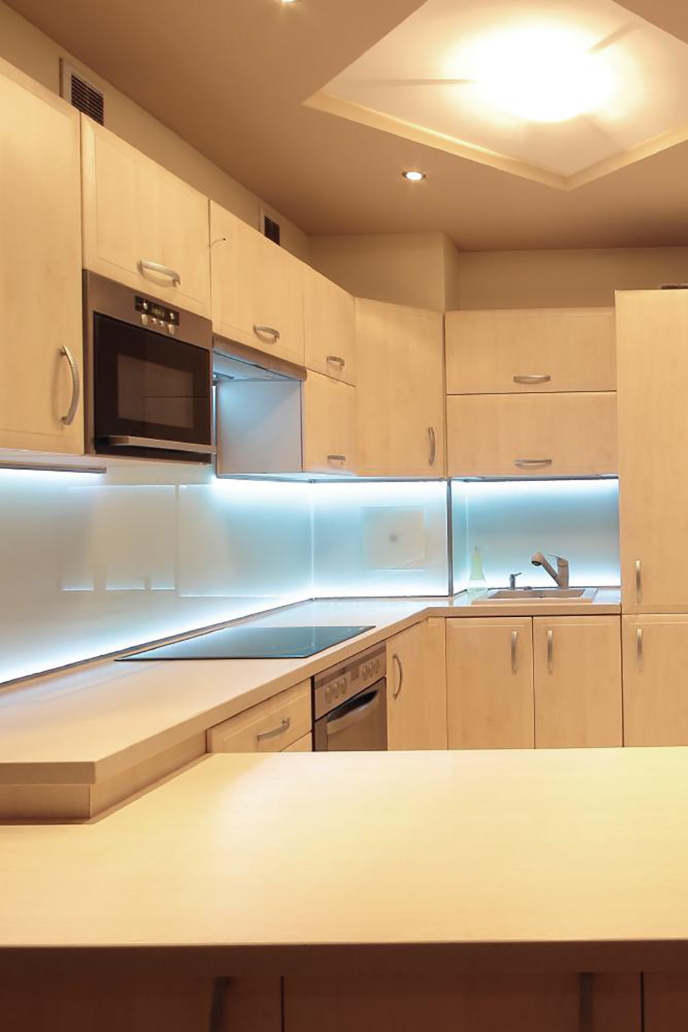 a kitchen with white cabinets and a black stove