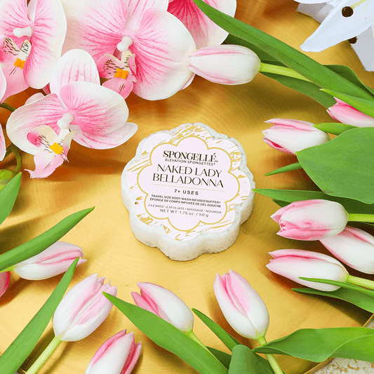 a group of pink flowers and a white label on a gold plate