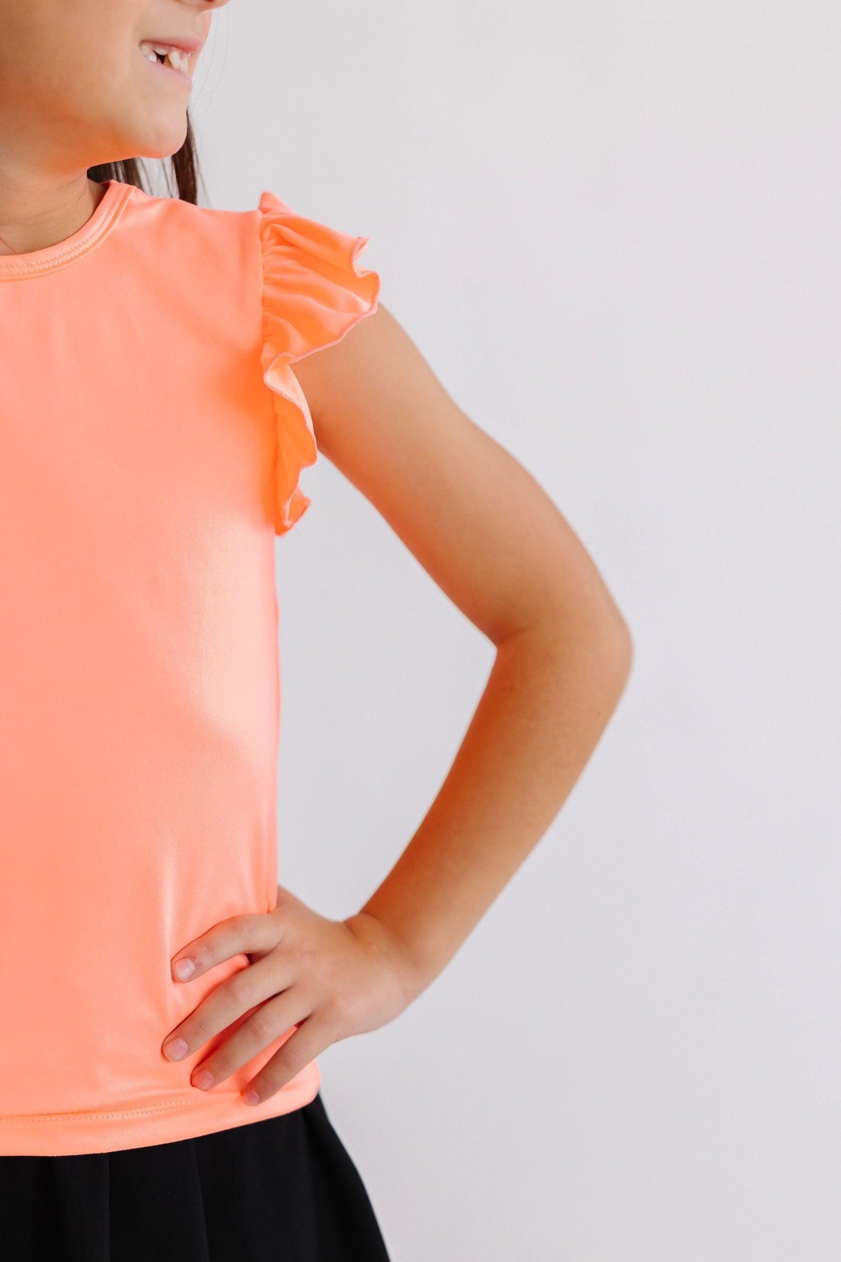 a girl with her hand on her hip