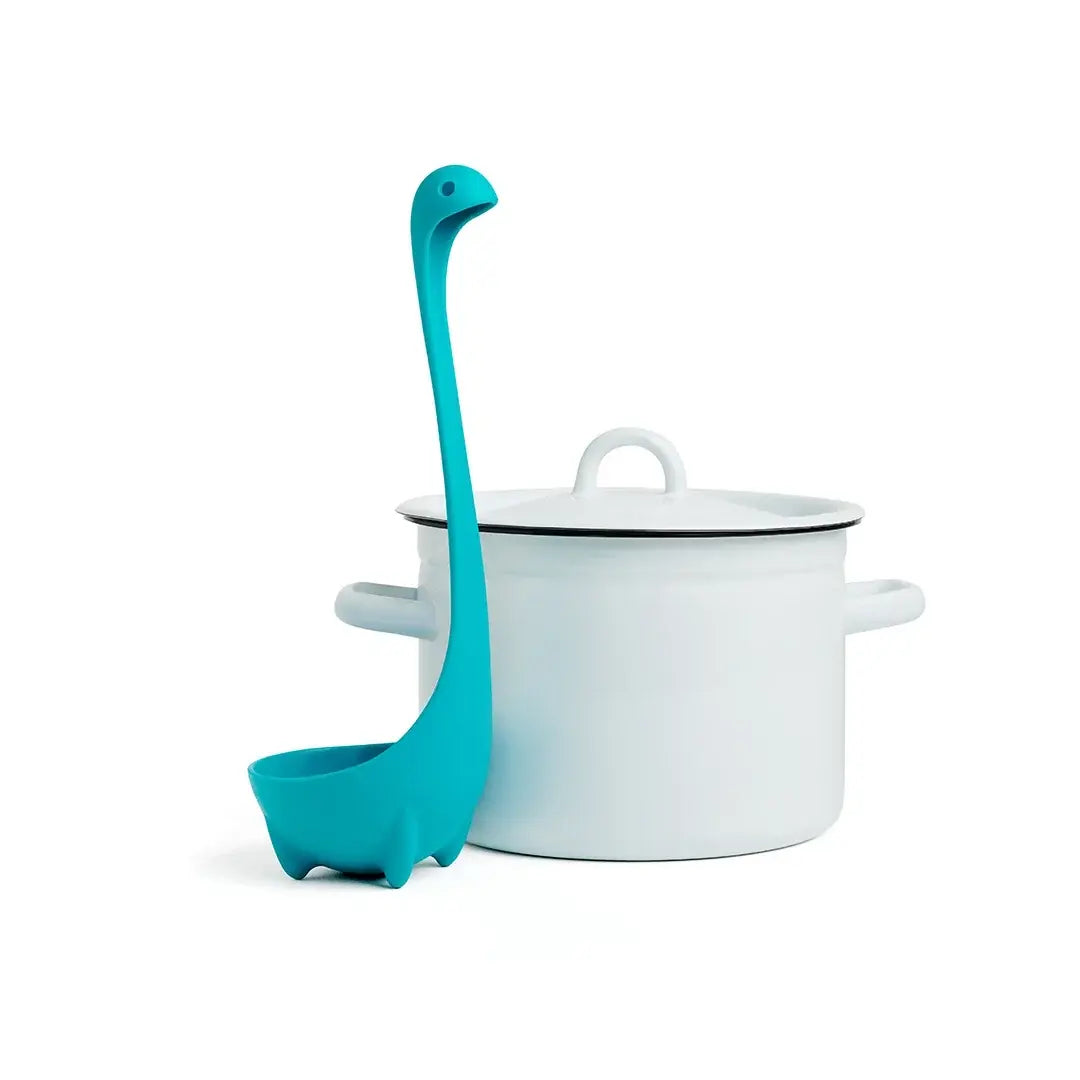 a blue ladle next to a white pot