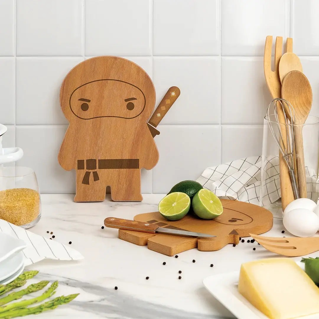 a wooden cutting board with a ninja figure and limes on a white counter