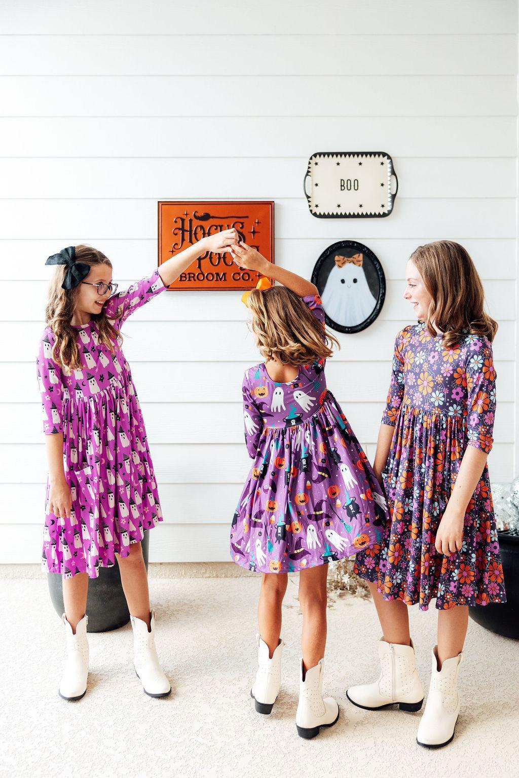 a group of girls wearing purple dresses