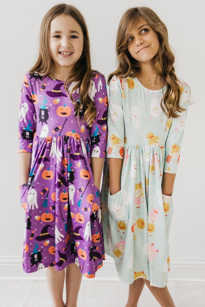two girls in dresses posing for a picture