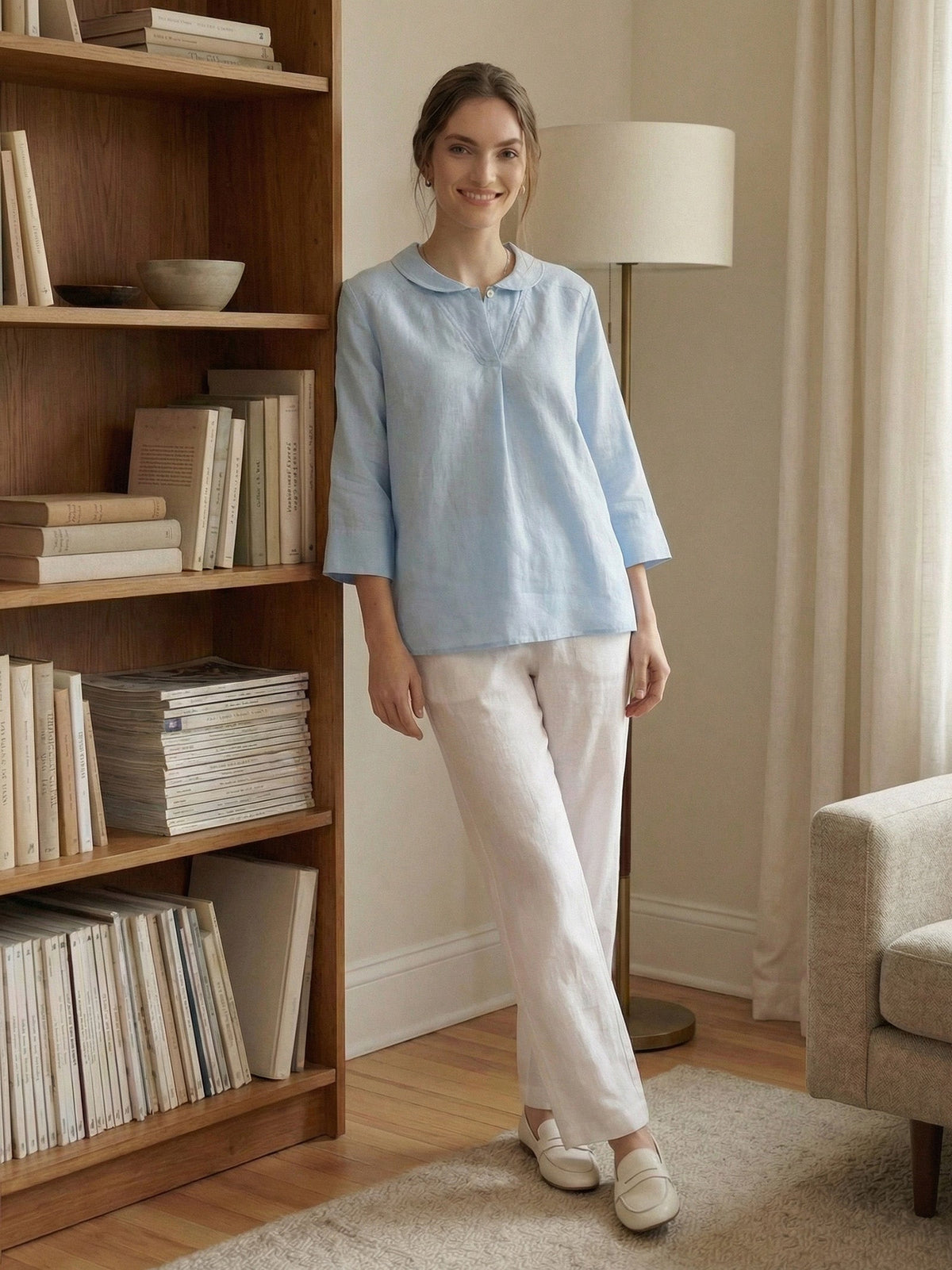 a woman standing next to a bookcase
