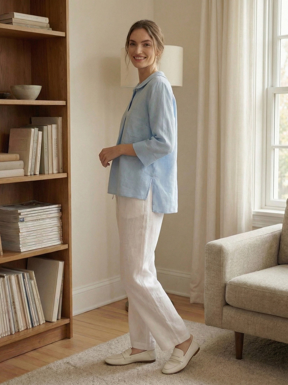 a woman standing in front of a bookcase