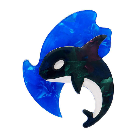 a blue and black whale shaped brooch