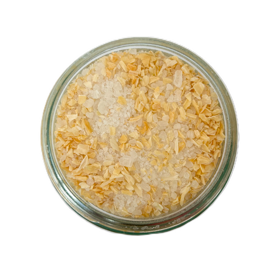 a glass container with salt and spices