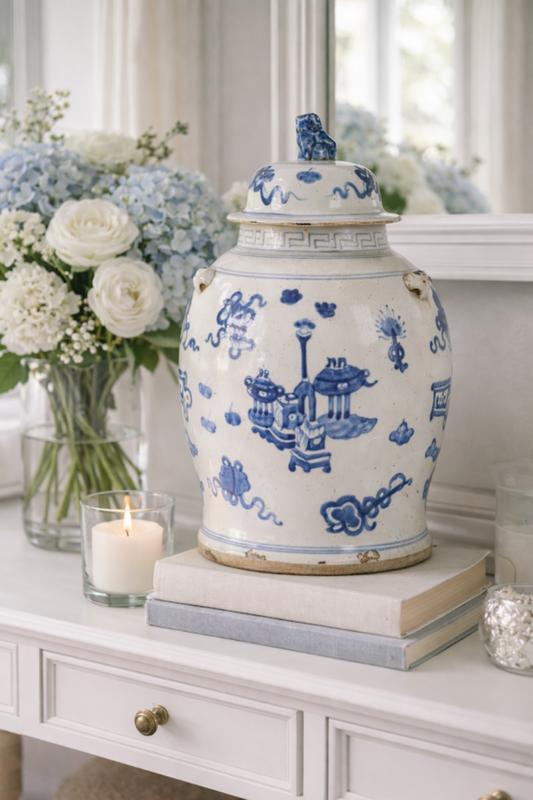 a vase and flowers on a shelf