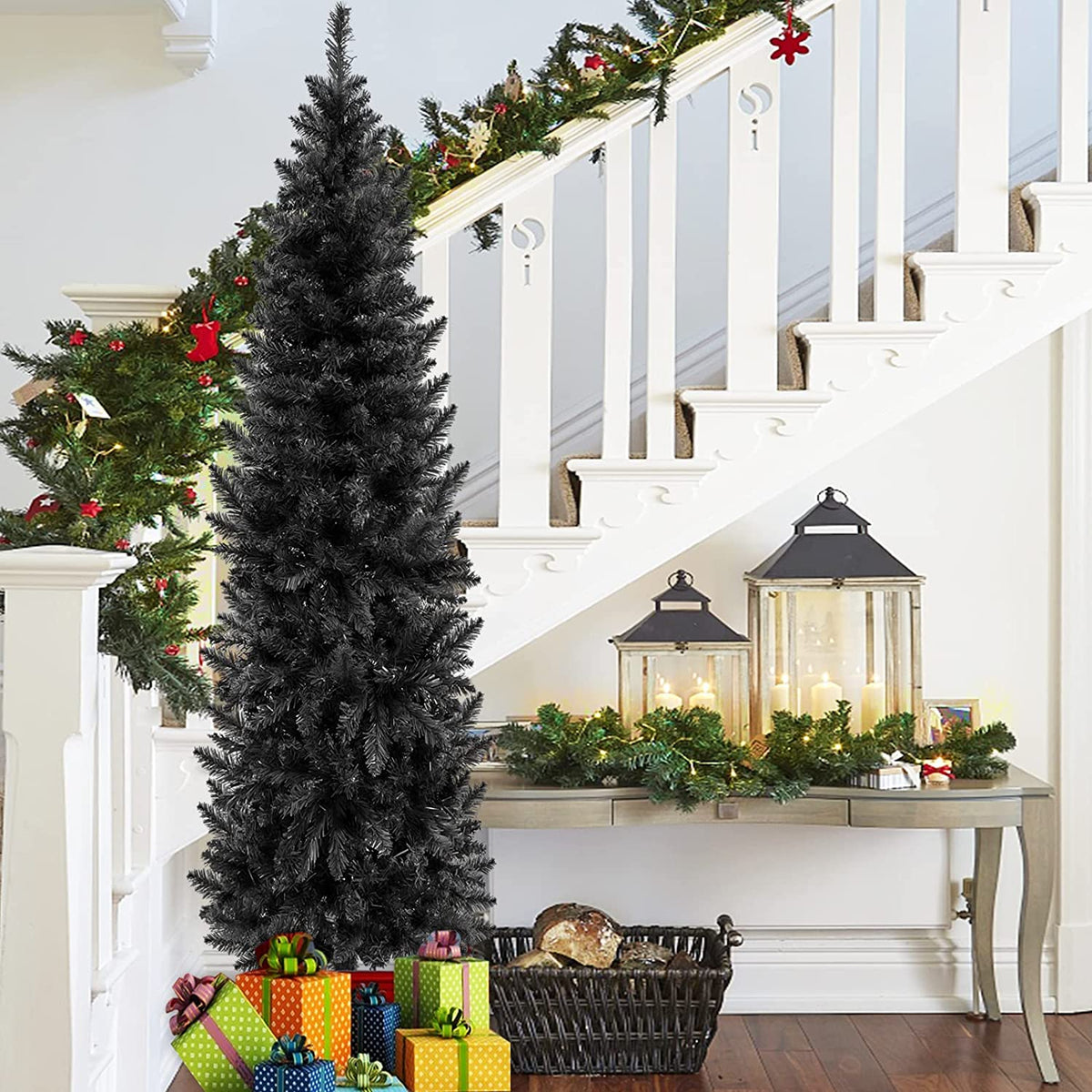 a christmas tree with presents under a staircase