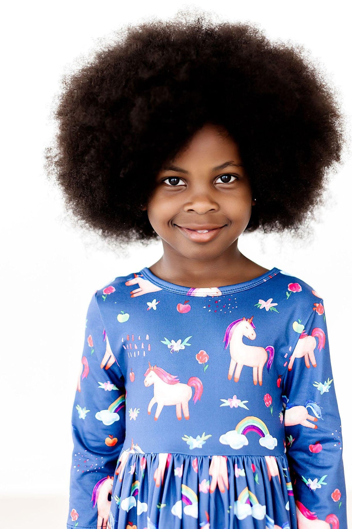 a girl with afro hair smiling