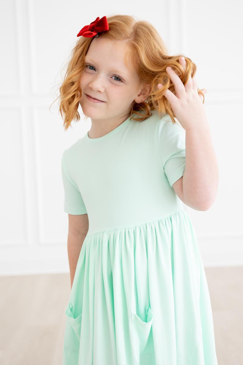 a girl in a green dress