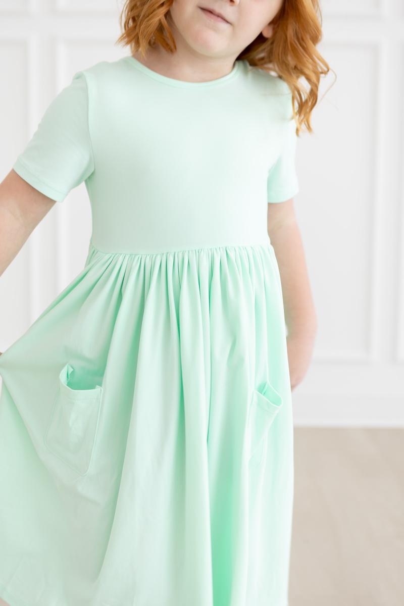 a girl wearing a light green dress