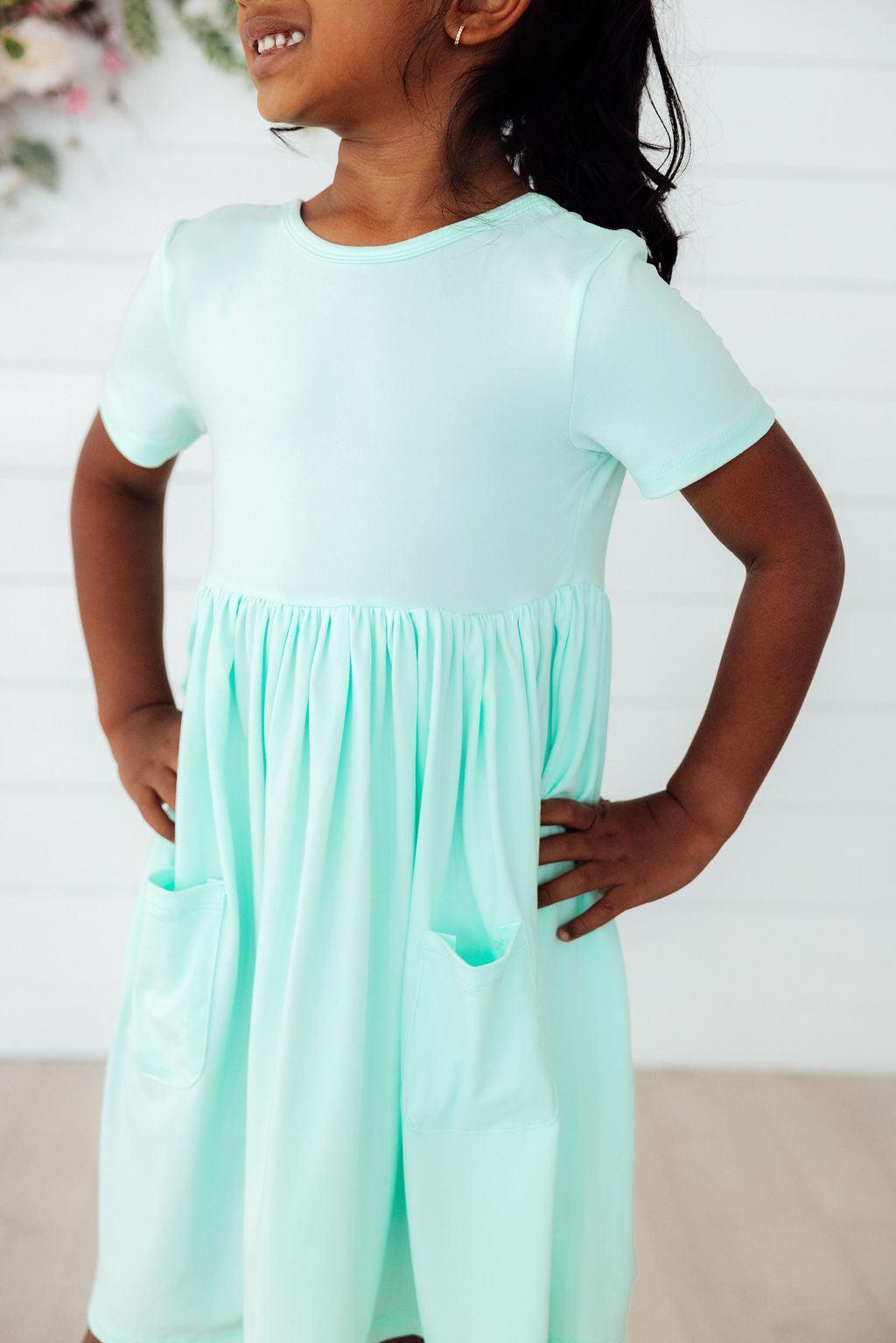 a girl in a light blue dress
