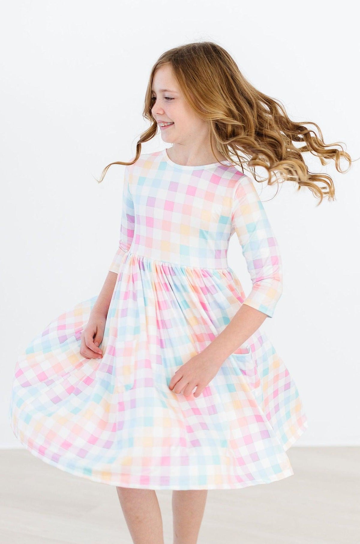 a girl in a plaid dress