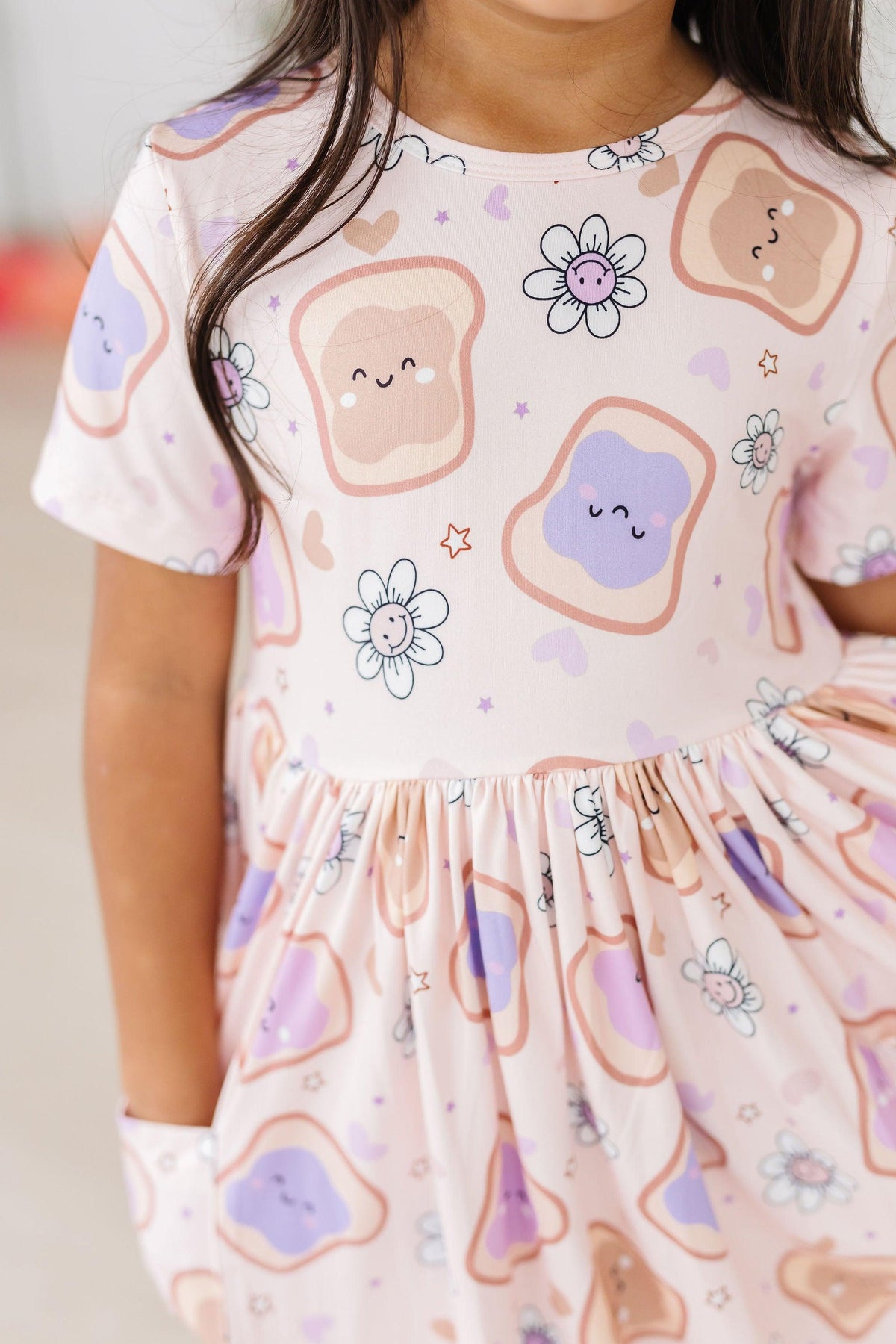 a girl wearing a dress with toast on it