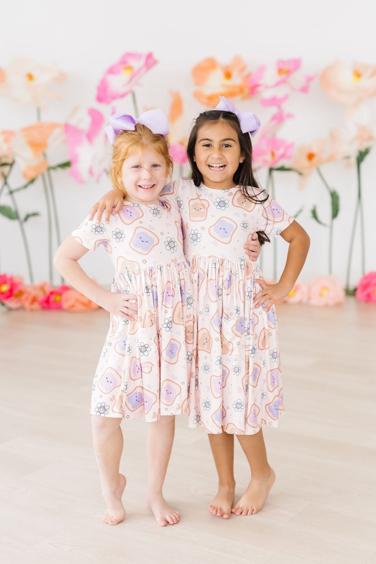 two girls in dresses with bows on their head