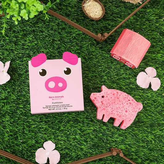 a pink pig shaped object on grass