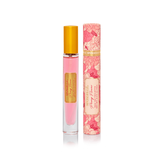 a bottle of perfume next to a tube of pink liquid
