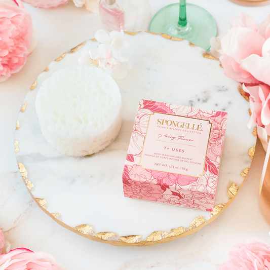 a pink box on a marble plate with pink flowers