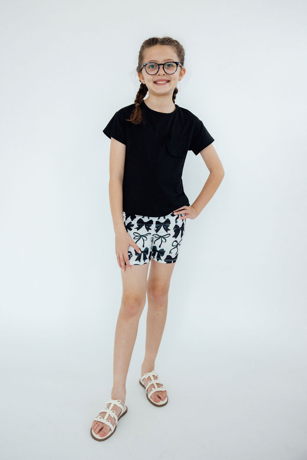 a girl in a black shirt and white shorts