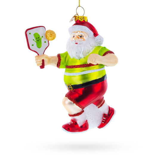 a christmas ornament with santa claus holding a paddle