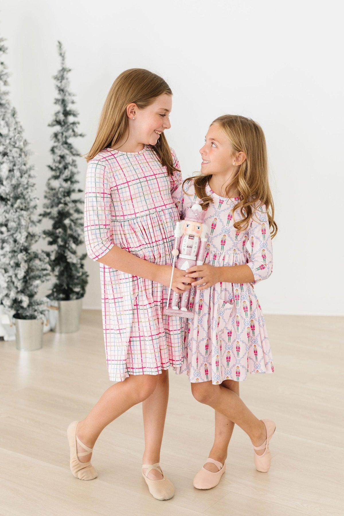 two girls holding a nutcracker