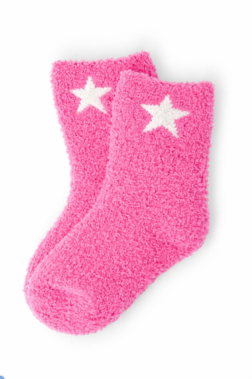 a pair of pink fuzzy socks with white stars
