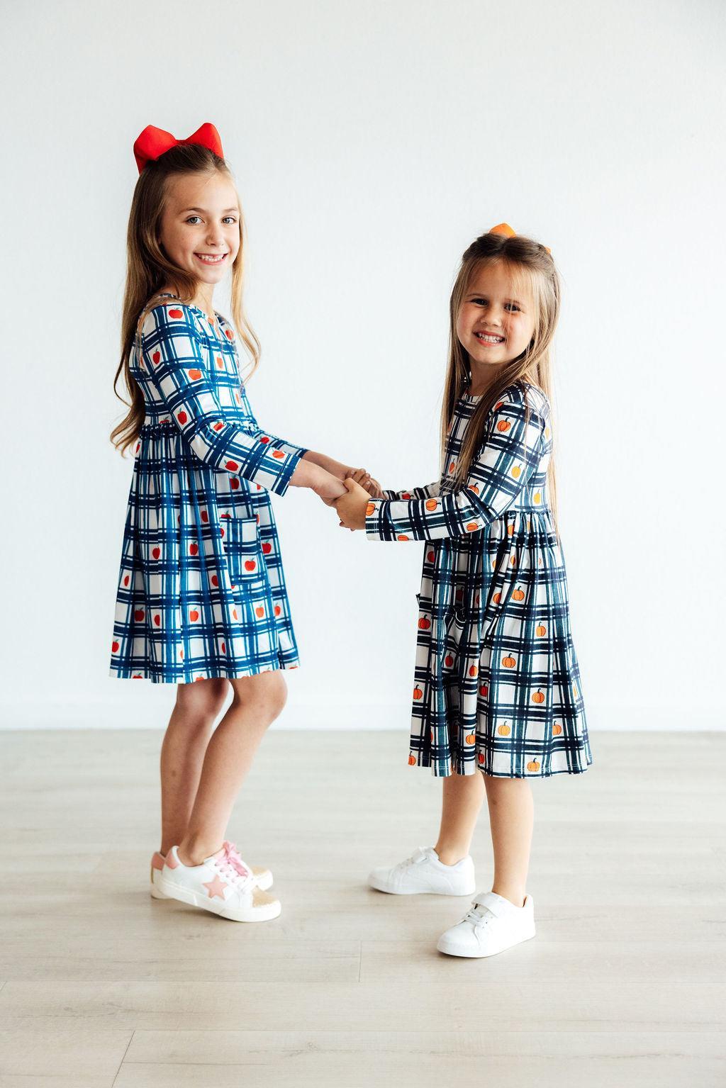 two girls holding hands and smiling