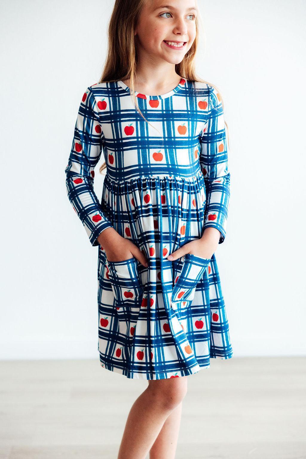a girl in a blue and white checkered dress