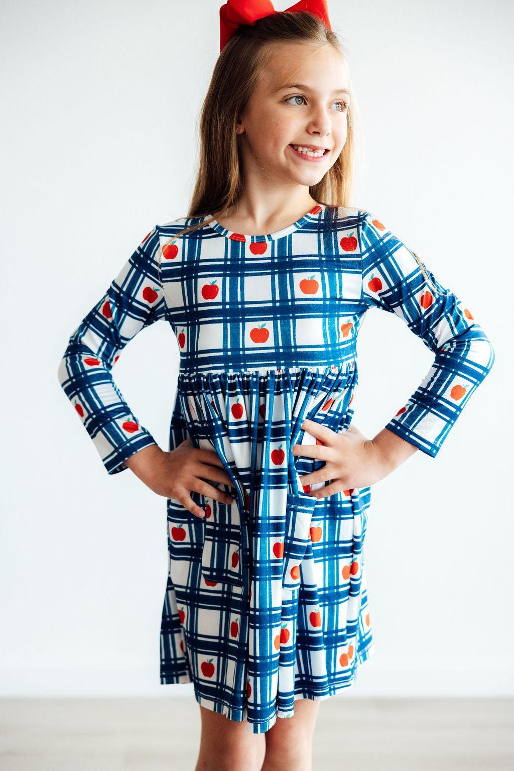 a girl in a blue and white checkered dress