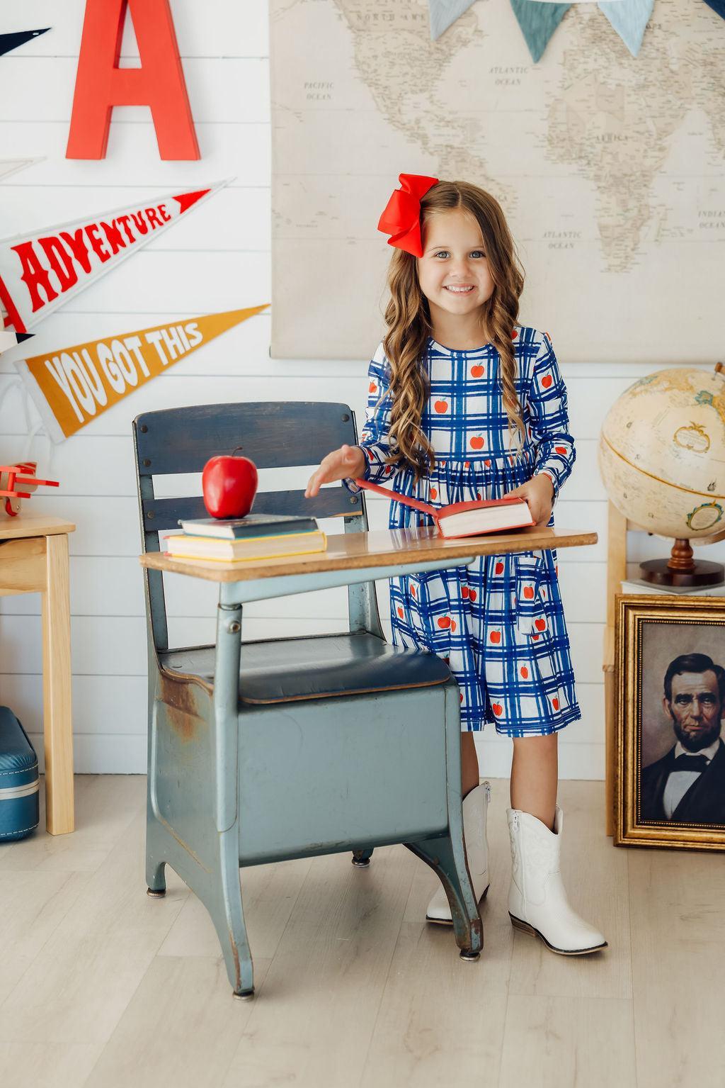 a girl standing at a desk