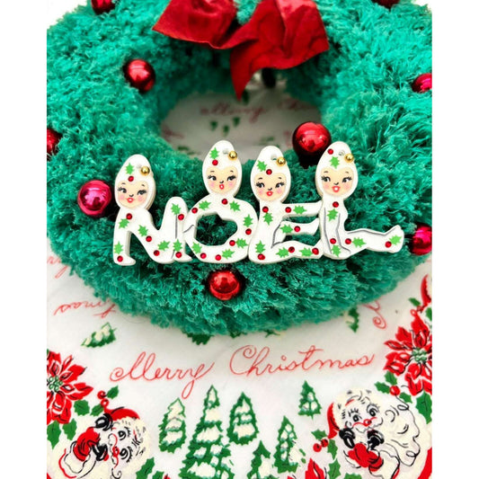 a green wreath with red and white decorations