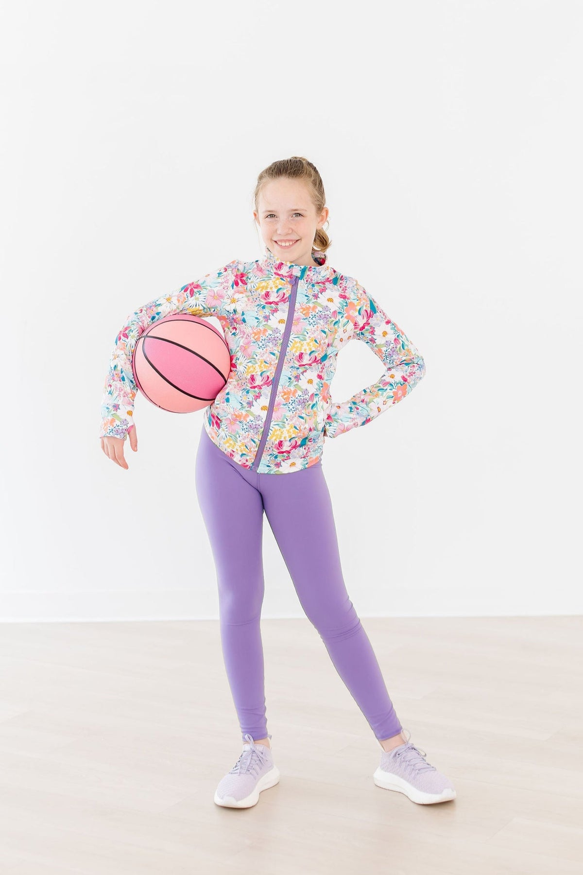 a girl holding a basketball