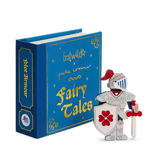 a toy knight with a sword and shield next to a blue book