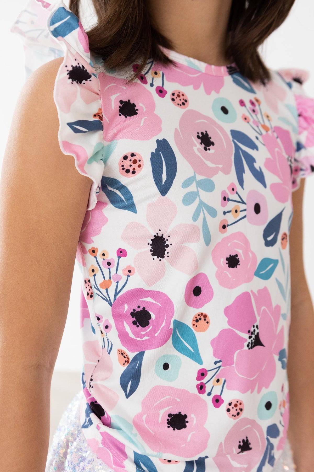 a girl wearing a floral shirt