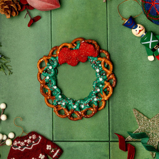a pretzel wreath on a green surface