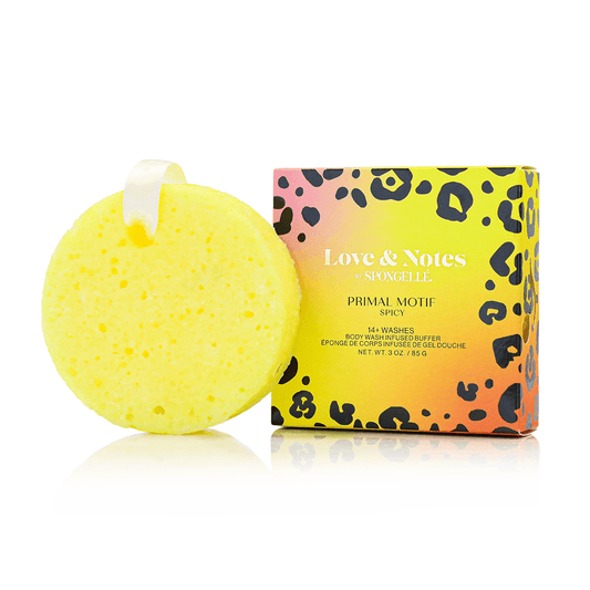 a yellow sponge with a white ribbon next to a box