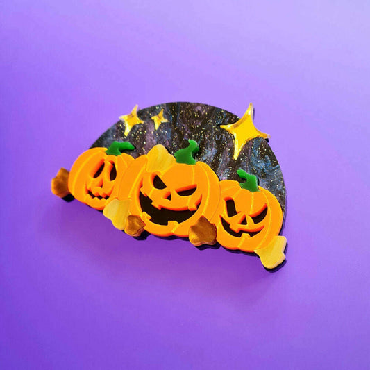 a group of pumpkins on a purple background