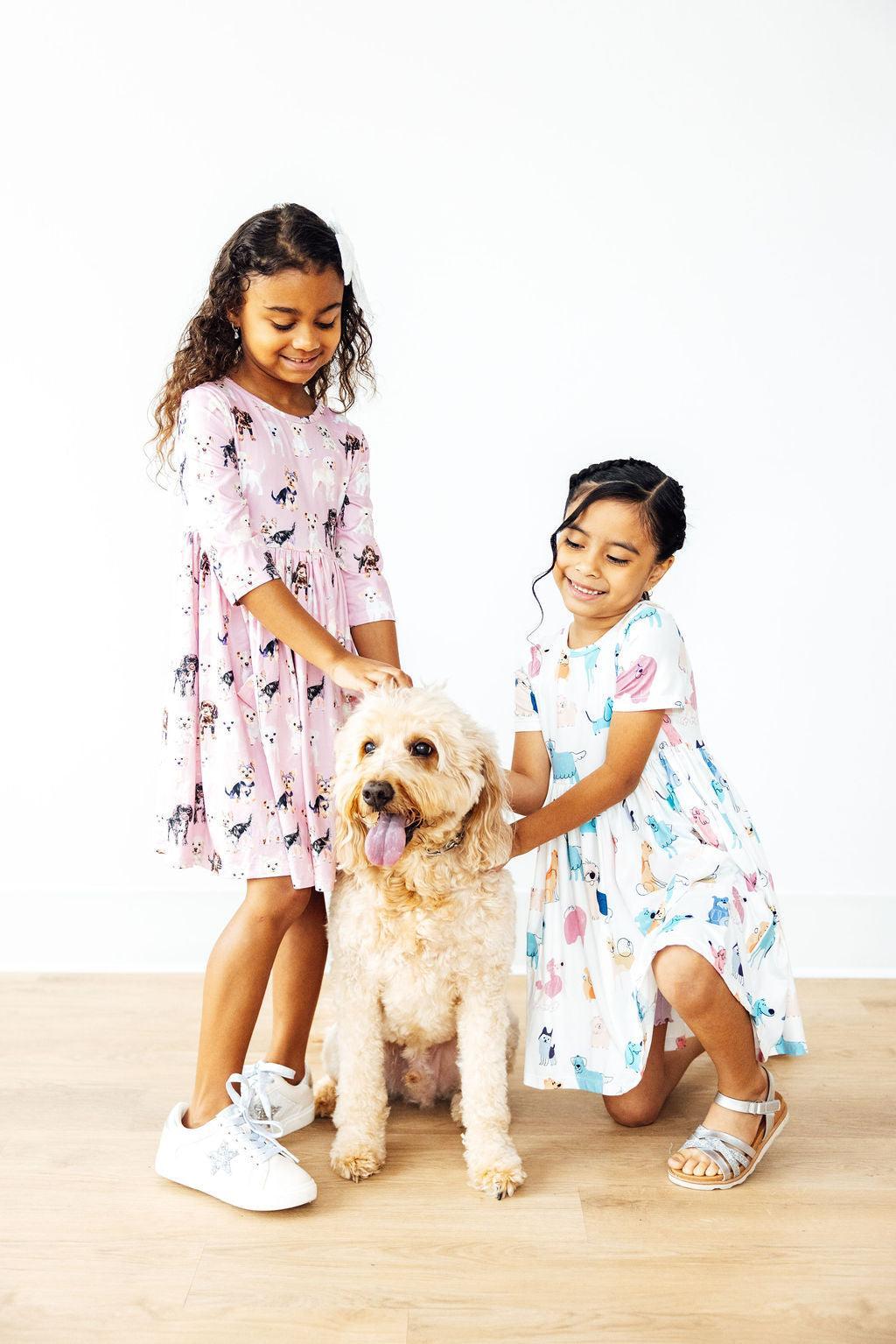 two girls petting a dog