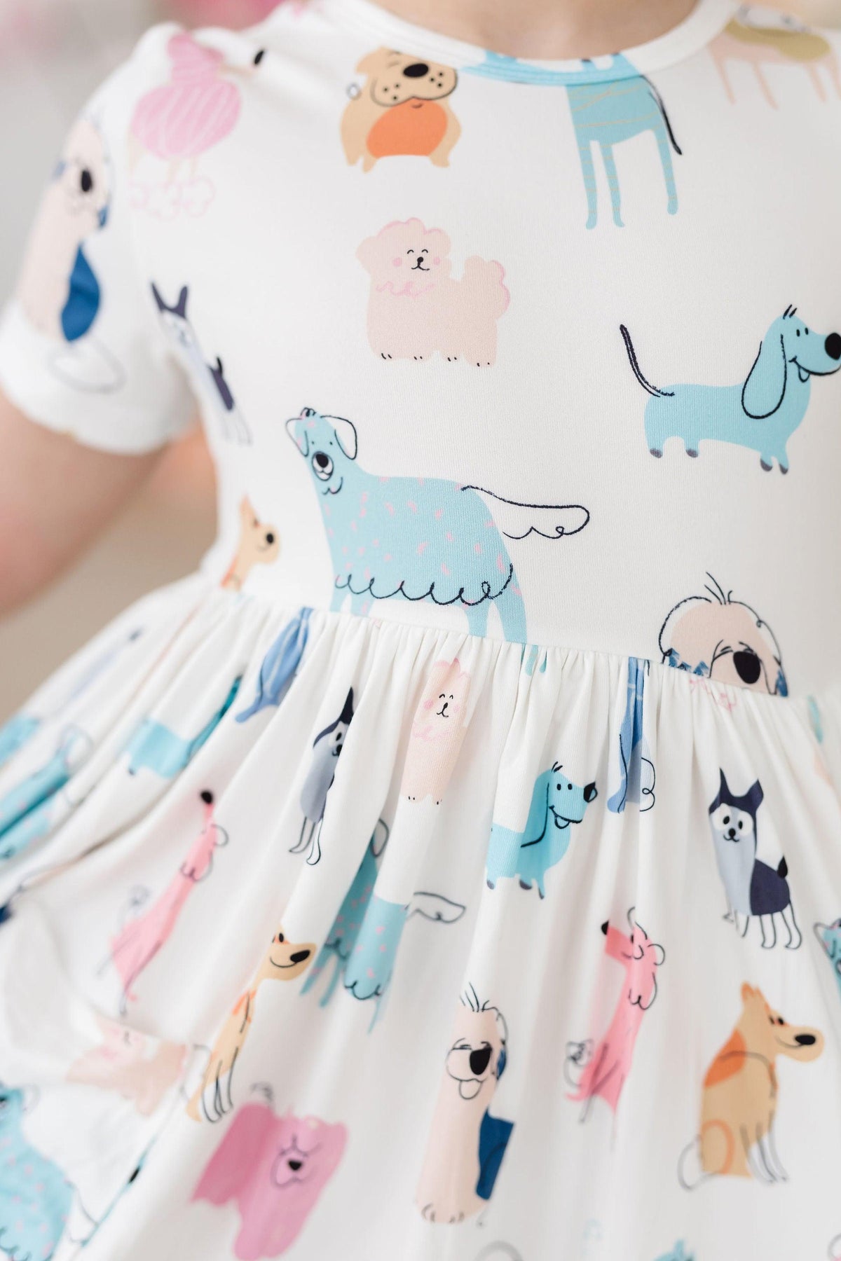 a person wearing a dress with cartoon dogs on it
