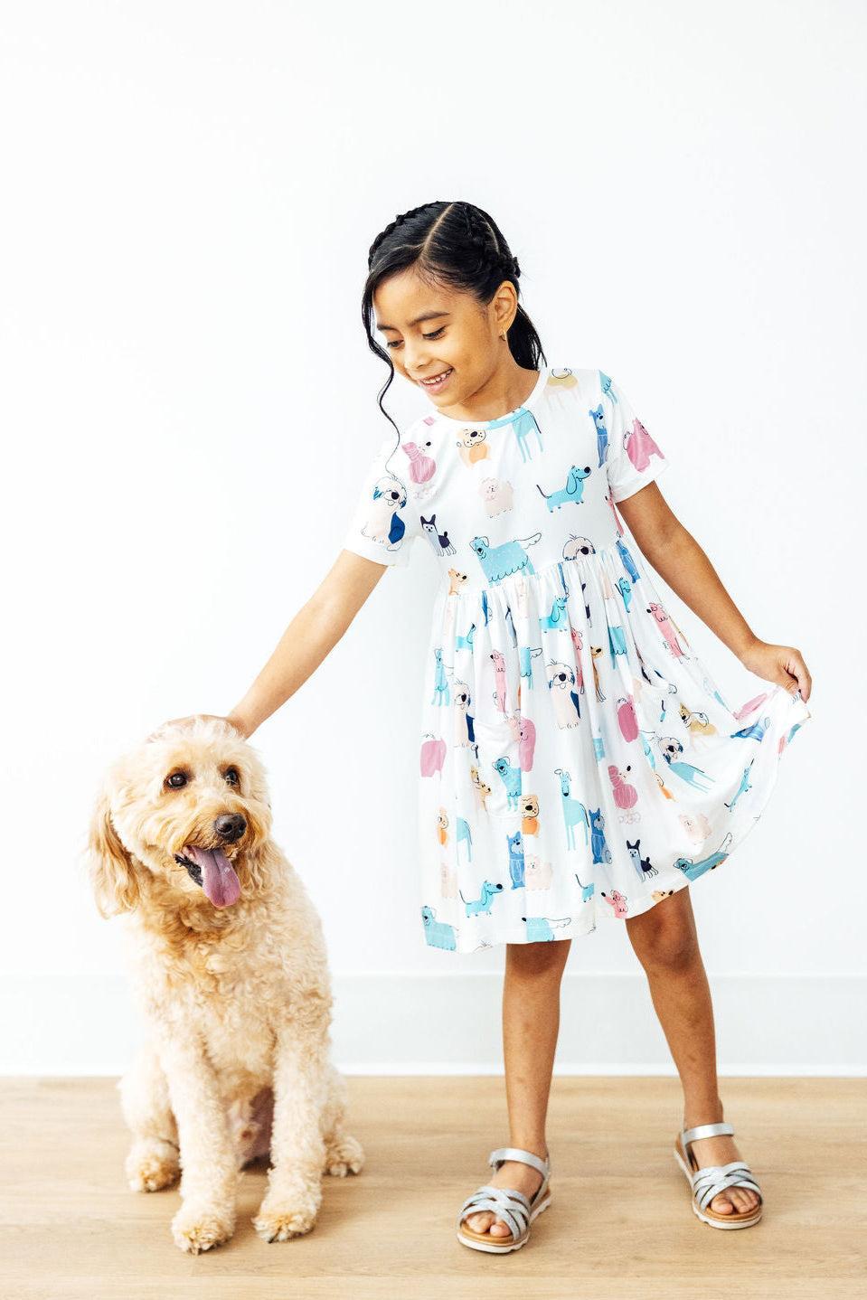 a girl petting a dog