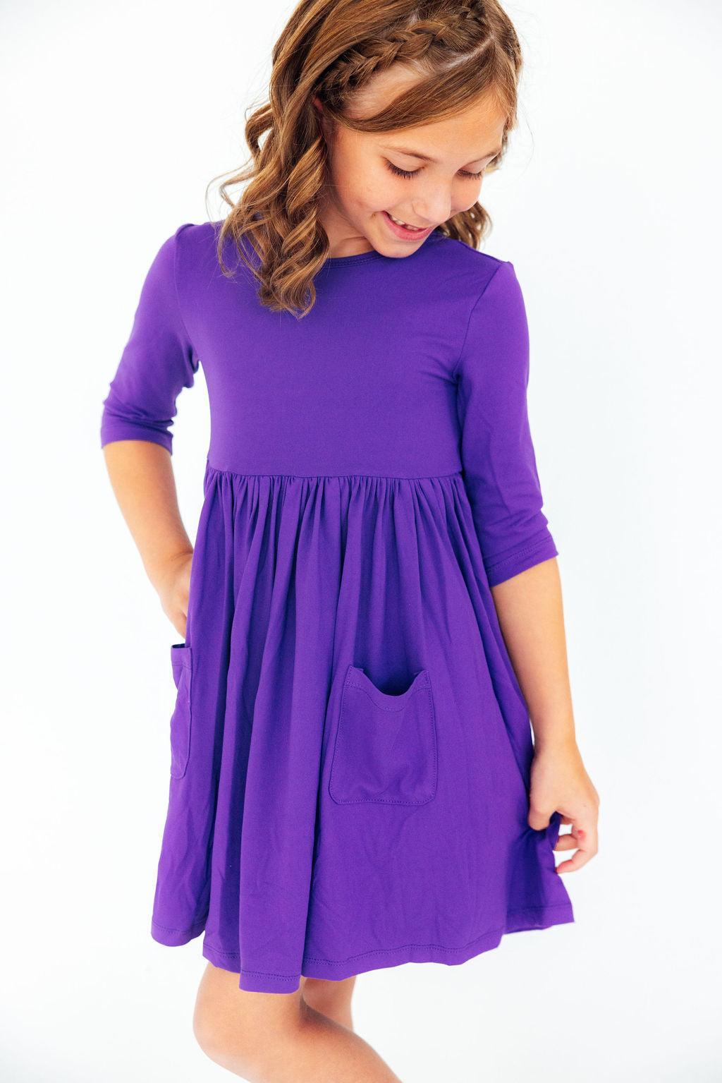 a girl in a purple dress