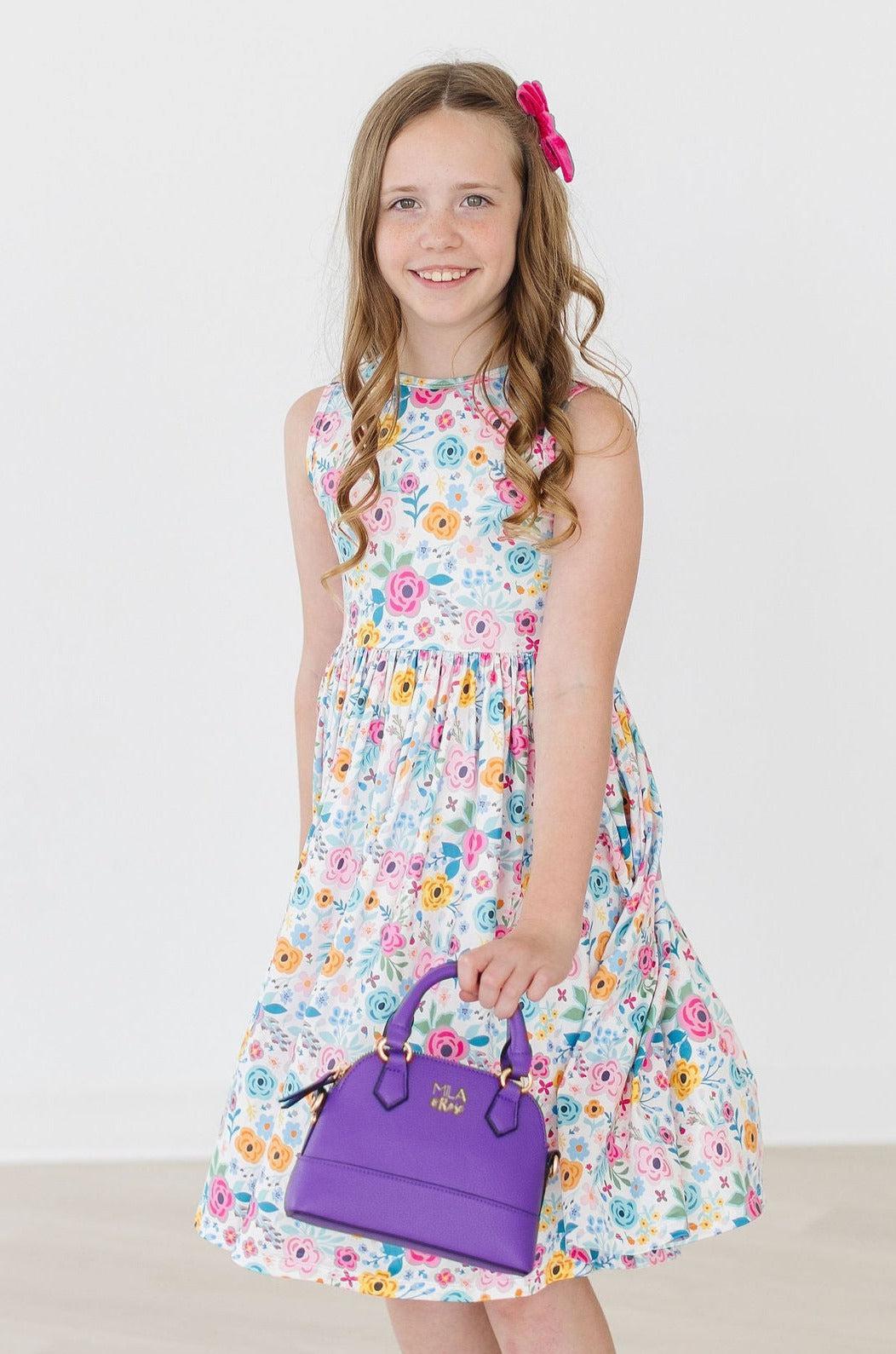 a girl holding a purple purse