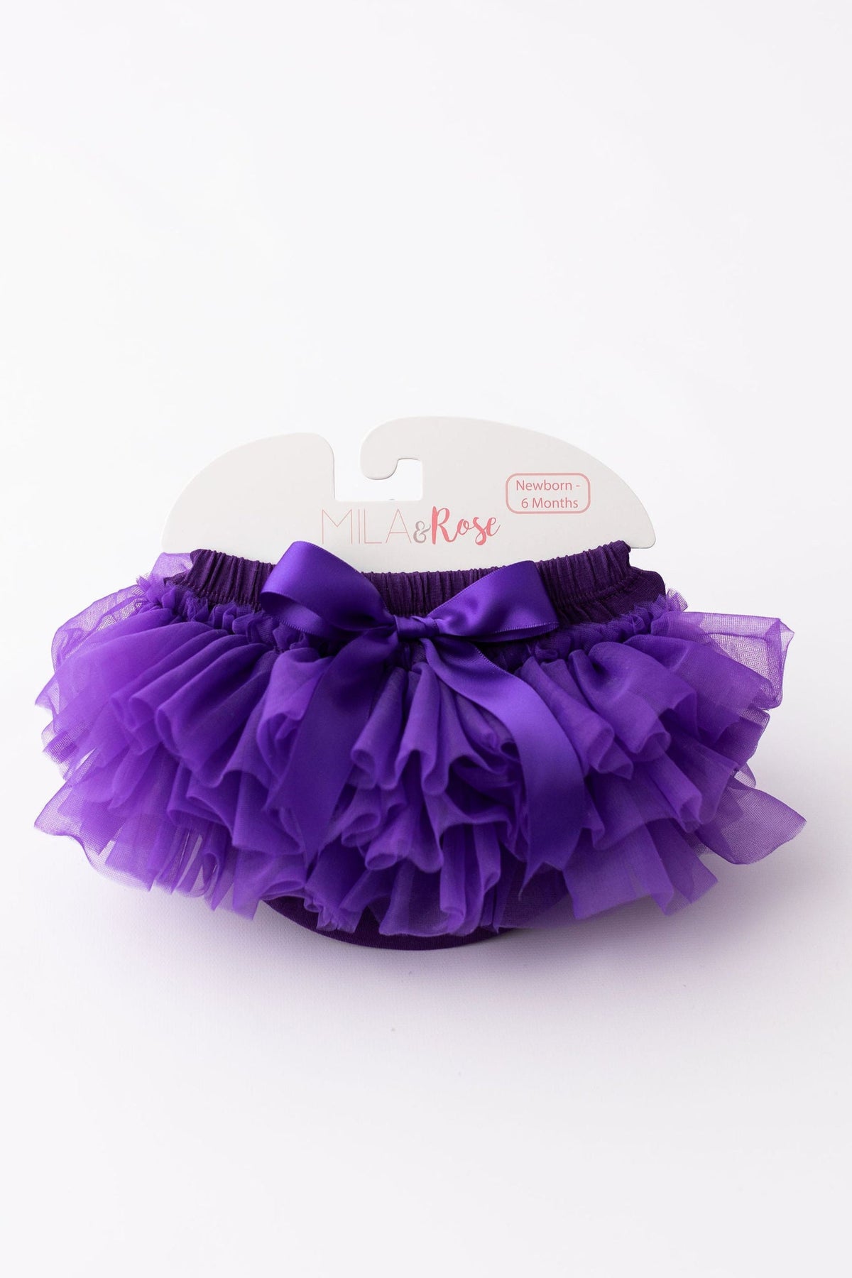 a purple ruffle skirt on a white surface