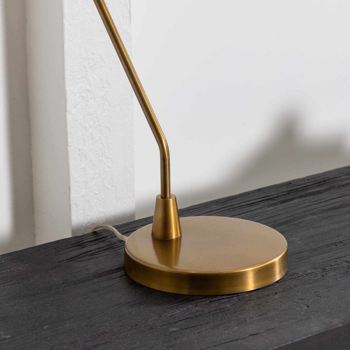 a gold lamp on a black surface