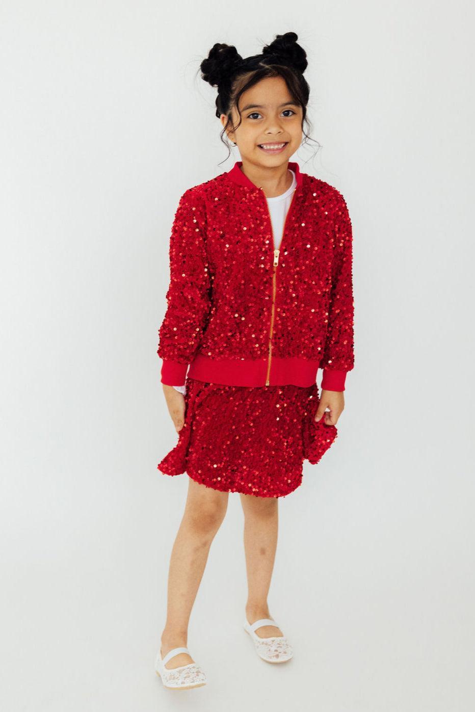 a girl in a red jacket and skirt